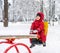 Little boy riding on swing in winter