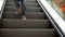 Little boy rises on the escalator. The boy goes down on escalator steps in shopping center. Christmas shopping. Slow