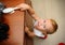 Little boy risking accident with falling furniture.