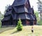 Little boy running and playing in front of the Gol Church, a stave church originally built in Gol city, now in Oslo.