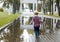 Little boy running into the puddle. Toddler playing in the park