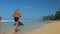 Little boy runs around father spending time on beach