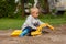 Little boy in the sandbox.