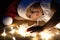 A little boy in a santa hat and a white T-shirt in the dark lies on the floor and plays with Christmas lights. The child