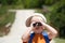 Little boy searching, searches with binoculars