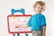 Little boy shows his family painted on whiteboard