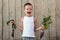 The little boy shows off a beet that he helped grow his mother in the garden. The concept of environmentally friendly rural settle