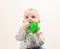 Little boy with sippy cup on light background