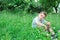 Little boy sits on a lawn of clover.