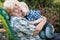 Little boy sitting on the arms of his beloved grandmother.Kisses and gentle hugs.Love generations.