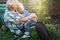 Little boy sitting on the arms of his beloved grandmother.Kisses and gentle hugs.Weekend in a country house.