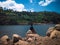 Little Boy Sitting On A Boulder Enjoy The Natural Atmosphere On The Edge Of Lake Water Dam