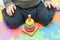 A little boy sitting on a playing mat, collects a multi-colored children`s pyramid. educational toys for children and hand wipes