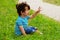 Little boy sitting and waving