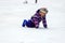 A little boy skates and falls on the ice in children skate rink Active family sport , winter holidays, sports club