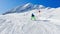 Little boy ski fast downhill alpine track on sunny day