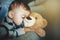 Little boy sleeping with a teddy bear