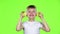 Little boy with slices of lemon licks them and shows grimaces. Green screen. Slow motion