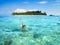 Little boy snorkeling next to tropical island