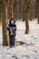 Little boy in the snow with crossbow