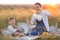 Little boy son and his pregnant mother on a picnic