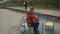 Little boy spinning on a swing at playground