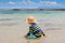 Little boy splashing in shallow sea water