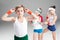 Little boy in sportswear adjusting eyeglasses and sporty girls standing behind