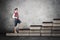 Little boy standing on books stair