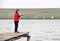 Little boy standing on the jetty with a spinning rod.