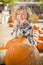 Little Boy Standing in a Rustic Ranch Setting at the Pumpkin Patch