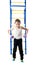 Little boy stands next to the stairs and horizontal bars and holds in hands dumbbell