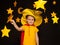 Little boy in stargazer costume among paper stars