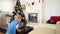 Little boy staying home in lockdown coronavirus covid-19 on Christmas holidays and video calling grandma and grandpa