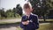 Little boy in suit holds a smartphone and plays the game on the street