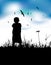 Little boy on summer field, silhouette on blue sky