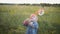 Little boy in the sunset catches soap bubbles in meadow. Relax with child in nature. Soap Bubble Games.