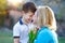 Little boy surprising mom with tulips outdoor