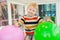 Little boy surrounded by colourful balloons