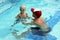 Little boy swimming with swim instructor