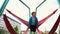 A little boy swinging on the swings on the playground