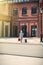 Little boy with teddy bear toy and suitcase stands on the desert