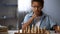 Little boy thinking on chess move, intelligent hobby, logic development, leisure