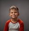 Little boy toddler adorable cute portrait. Smiling little boy full of happy feelings. Portrait, isolated over grey