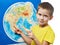 Little boy with toy giraffe shows Africa on world map