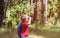 Little boy travel in nature looking through binoculars