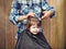 A little boy is trimmed in the hairdresser`s