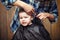 A little boy is trimmed in the hairdresser`s