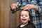 A little boy is trimmed in the hairdresser`s bright emotions on