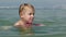 Little boy trying to swim on board in the sea